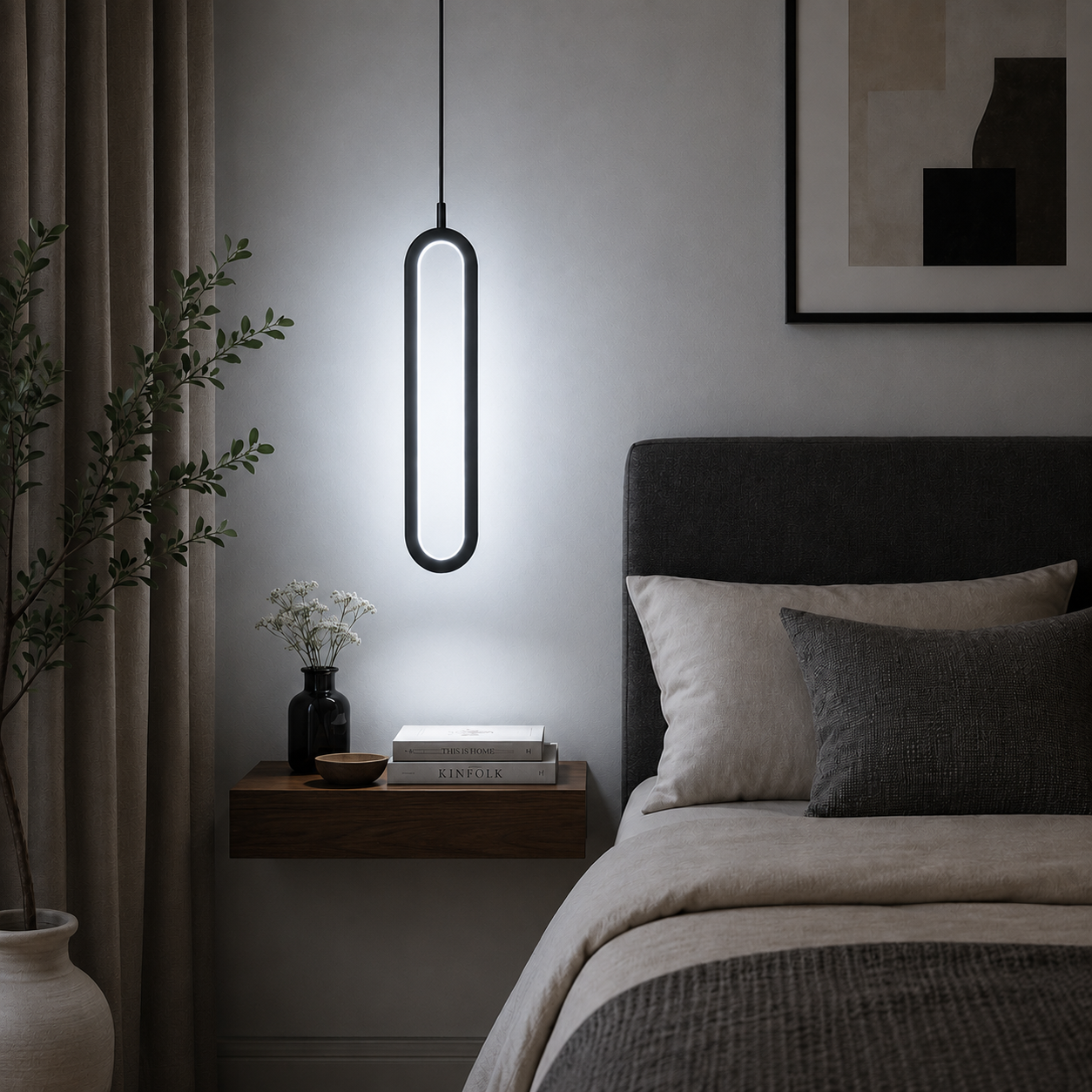 Modern black LED pendant light with cool white illumination above a bedside table in a contemporary minimalist bedroom.