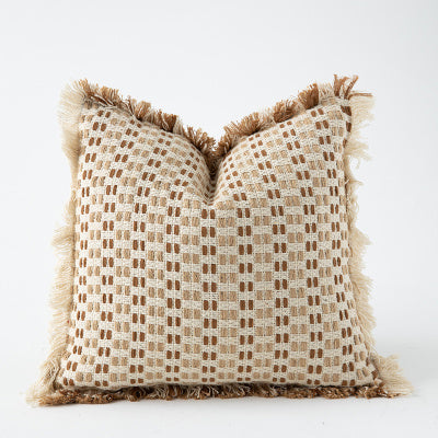 Natural woven cushion cover with textured pattern and decorative fringe edging for modern home décor