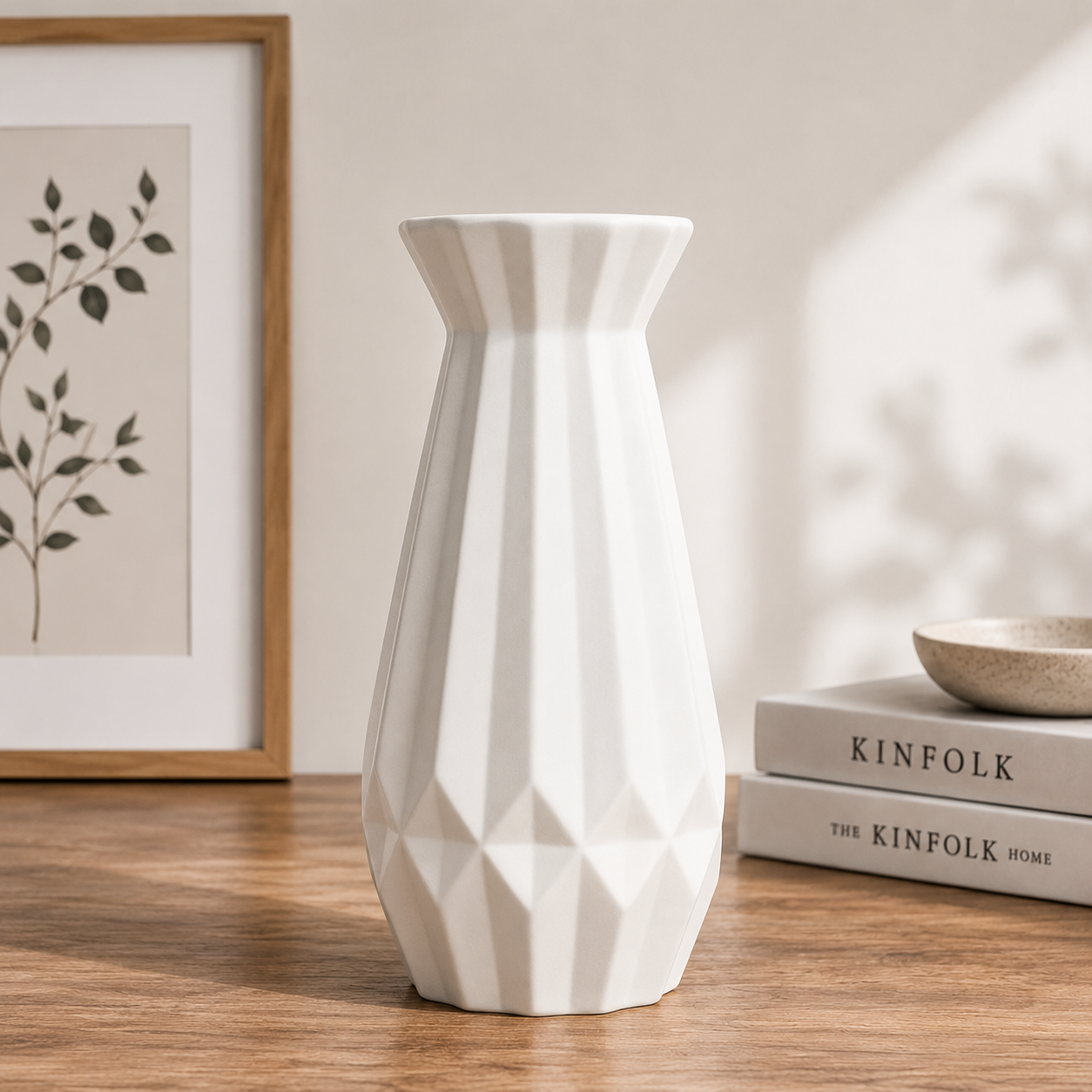 White modern ceramic decorative vase with a geometric textured finish styled on a wooden table in a Scandinavian-inspired home interior.